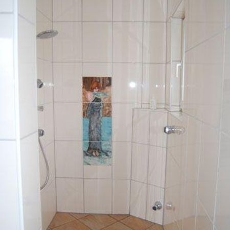 Bodengleiche Dusche mit hellen Fliesen