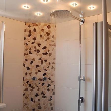 Regendusche mit gemusterten Fliesen in Mosaik-Optik